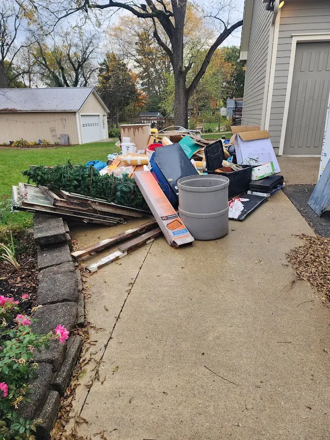 Dumpster being loaded with debris for 12 Yard Dumpster Rental in Cumberland